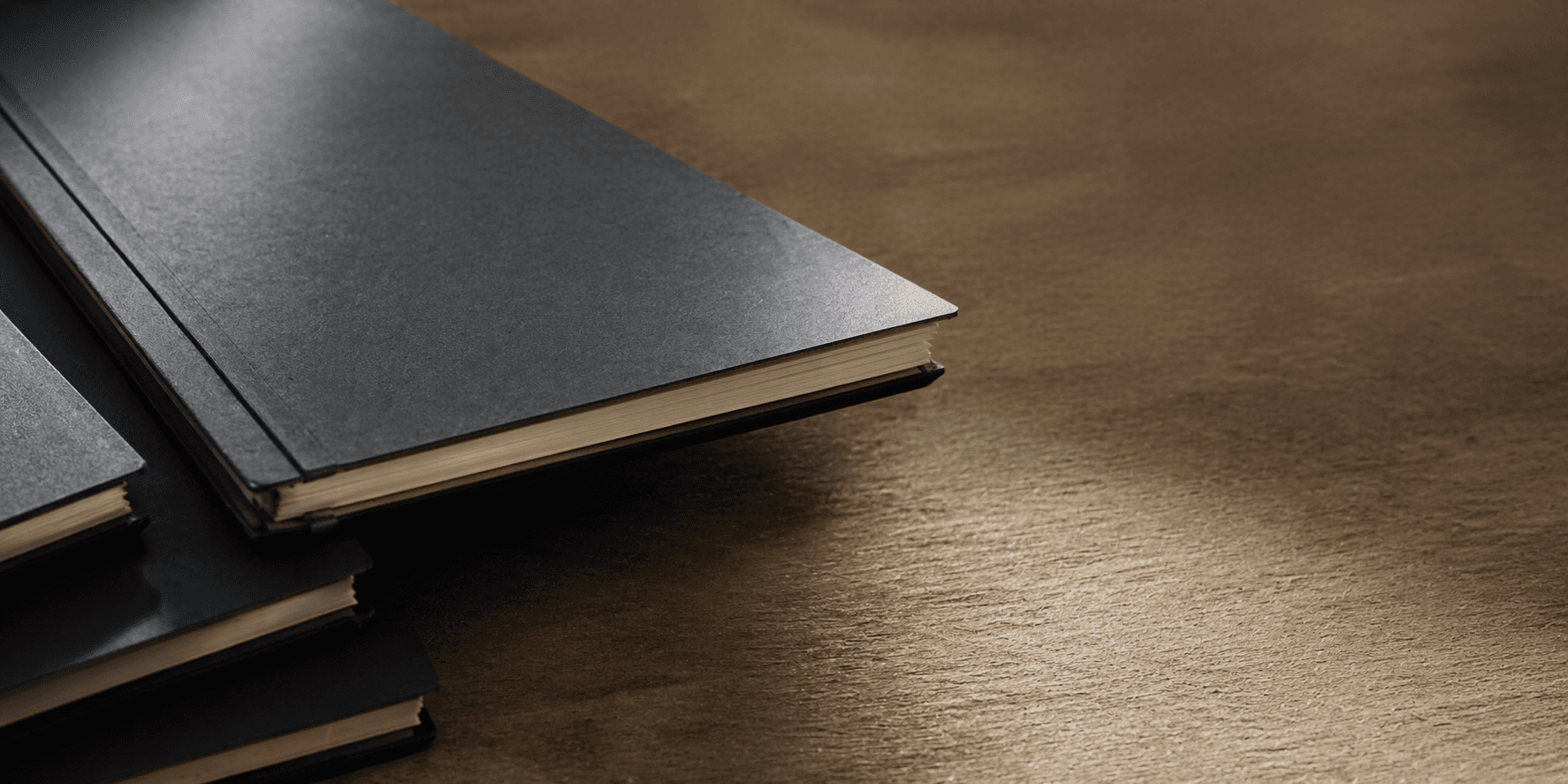 Bound technical reports stacked on a desk.